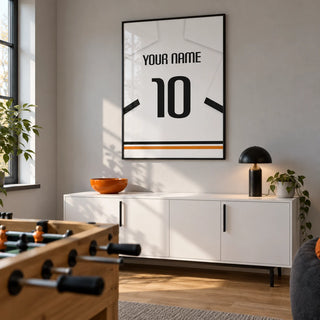 Football Shirt Poster in White with Black Sleeve Bands, framed on the wall of a football fan's games den in a converted UK dining room with a pale grey wall