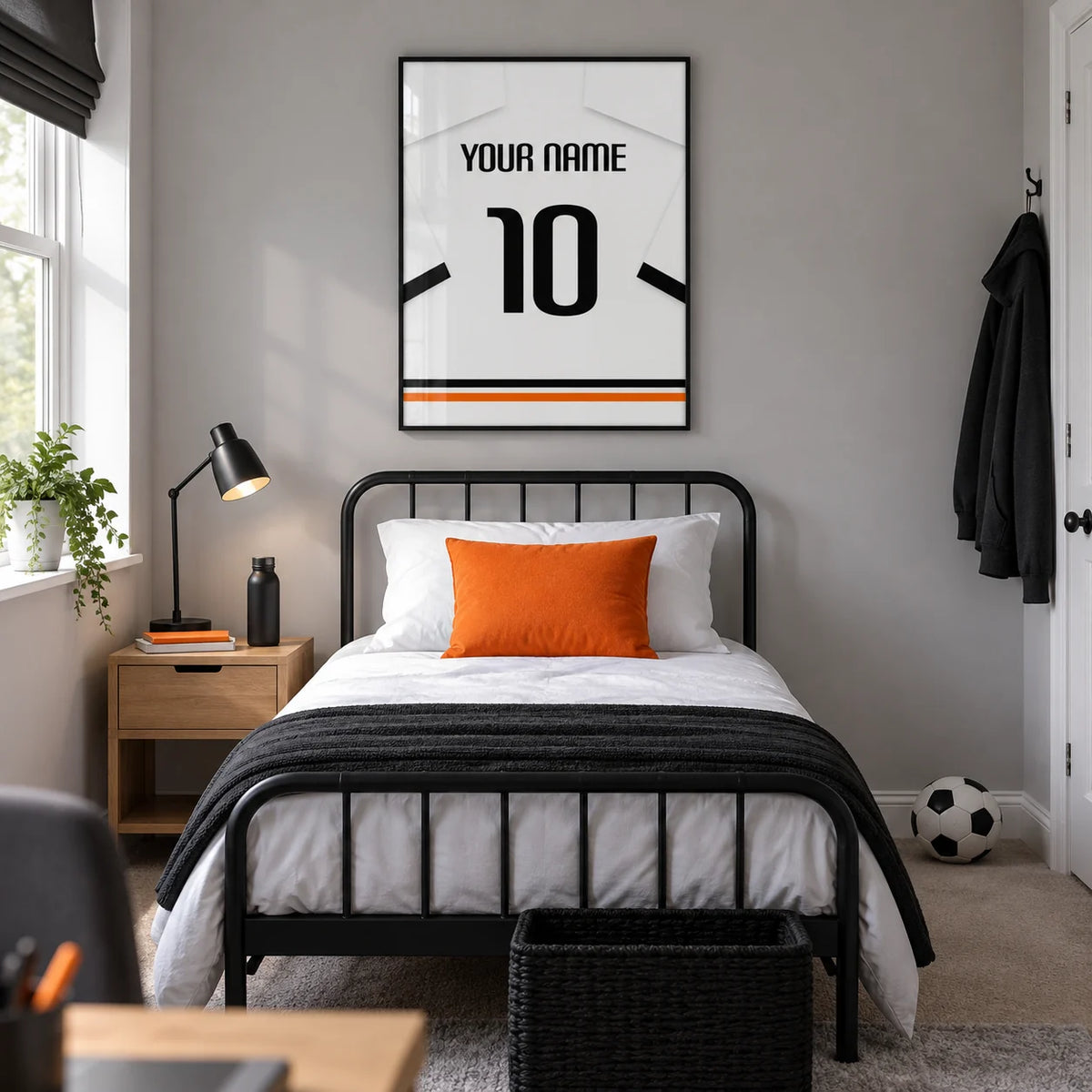 Football Shirt Poster in White with Black Sleeve Bands, framed on the wall of a modern teenage football fan's bedroom (13-17) in a UK family home with a pale grey wall