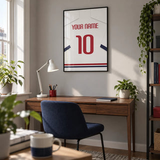 Football Shirt Poster in White with Navy Sleeves and Red Number, framed on the wall of a compact home study in a young adult's UK terrace with a soft grey wall and clean modern furniture