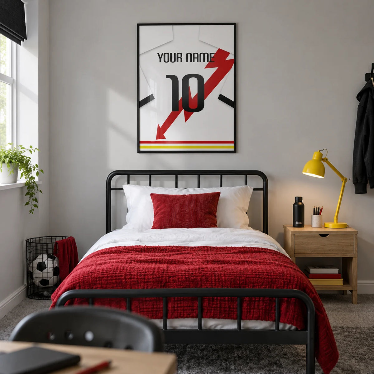 Football Shirt Poster in White with Red Lightning Bolt, framed on the wall of a contemporary football-loving teenager’s single bedroom (13-17) in a UK family home with a pale grey wall