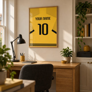 Football Shirt Poster in Yellow with Black Sleeve Stripes, framed on the wall of a football enthusiast’s tidy home office in a UK terraced house with a warm white wall
