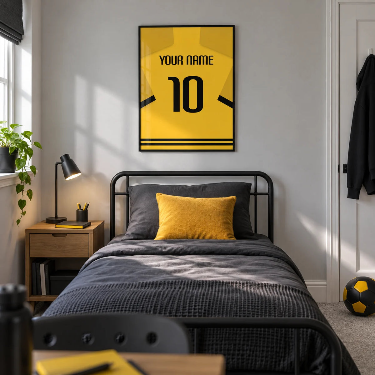 Football Shirt Poster in Yellow with Black Sleeve Stripes, framed on the wall of a modern football-loving teenager’s single bedroom (13-17) in a UK family home with a pale grey wall
