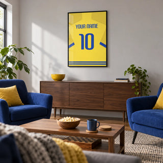 Football Shirt Poster in Yellow with Blue Trim, framed on the wall of a relaxed football-viewing and games den in a UK family home with a pale grey wall in a living room