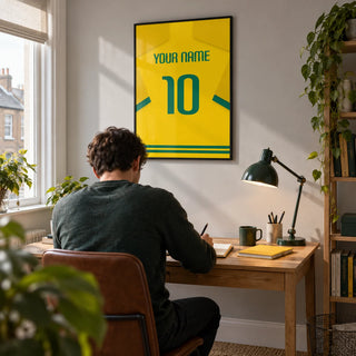 Football Shirt Poster in Yellow with Green Number, framed on the wall of a bright home study for a young adult football fan (22-30) in a UK terrace with a pale grey wall