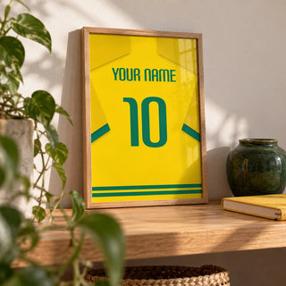 Football Shirt Poster in Yellow with Green Number, a small A4 framed print leaning on an oak shelf in a living room