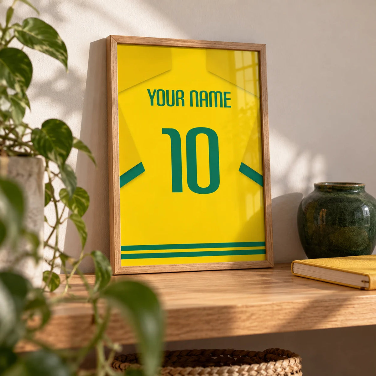 Football Shirt Poster in Yellow with Green Number, a small A4 framed print leaning on an oak shelf in a living room
