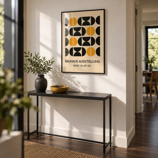 Geometric Bauhaus Poster, framed on the wall of a modern hallway with a white wall and dark wood floor