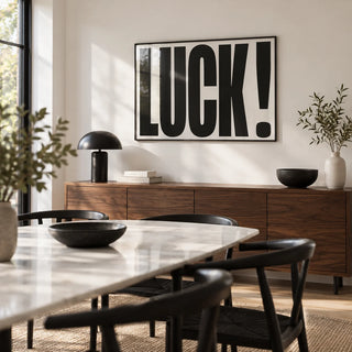 Good Luck Print, framed on the wall of a modern dining room with a white wall