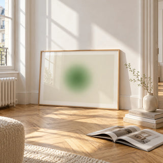 Green Aura Poster, framed and leaning on the parquet floor of a bright living room