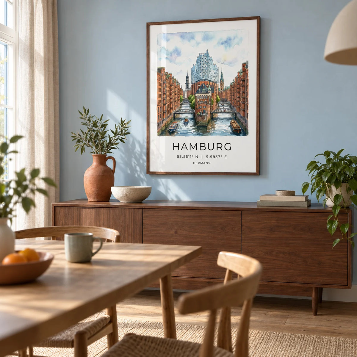 Hamburg Cityscape Art Print, framed on the wall of a relaxed dining room in a renovated UK terrace with a pale blue wall and plain oak floor