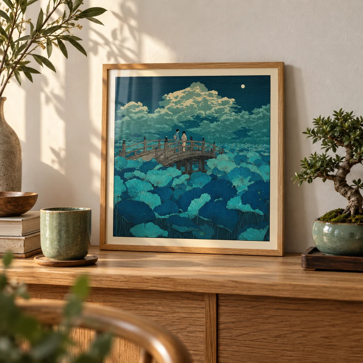 Hasui Kawase Japanese Woodblock Lotus, a small A4 framed print leaning on an oak shelf in a living room