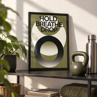 Home Gym Wall Art, a small A4 framed print leaning on a black metal shelf in a living room