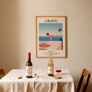 Prints of Cocktails framed aviation cocktail illustration above a dining table with wine bottles and glass
