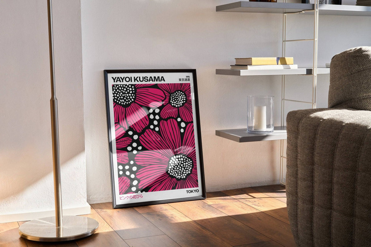 Print leaning on a floor next to a brown cushion with pink daisies and white dots in a black and white pop-art style