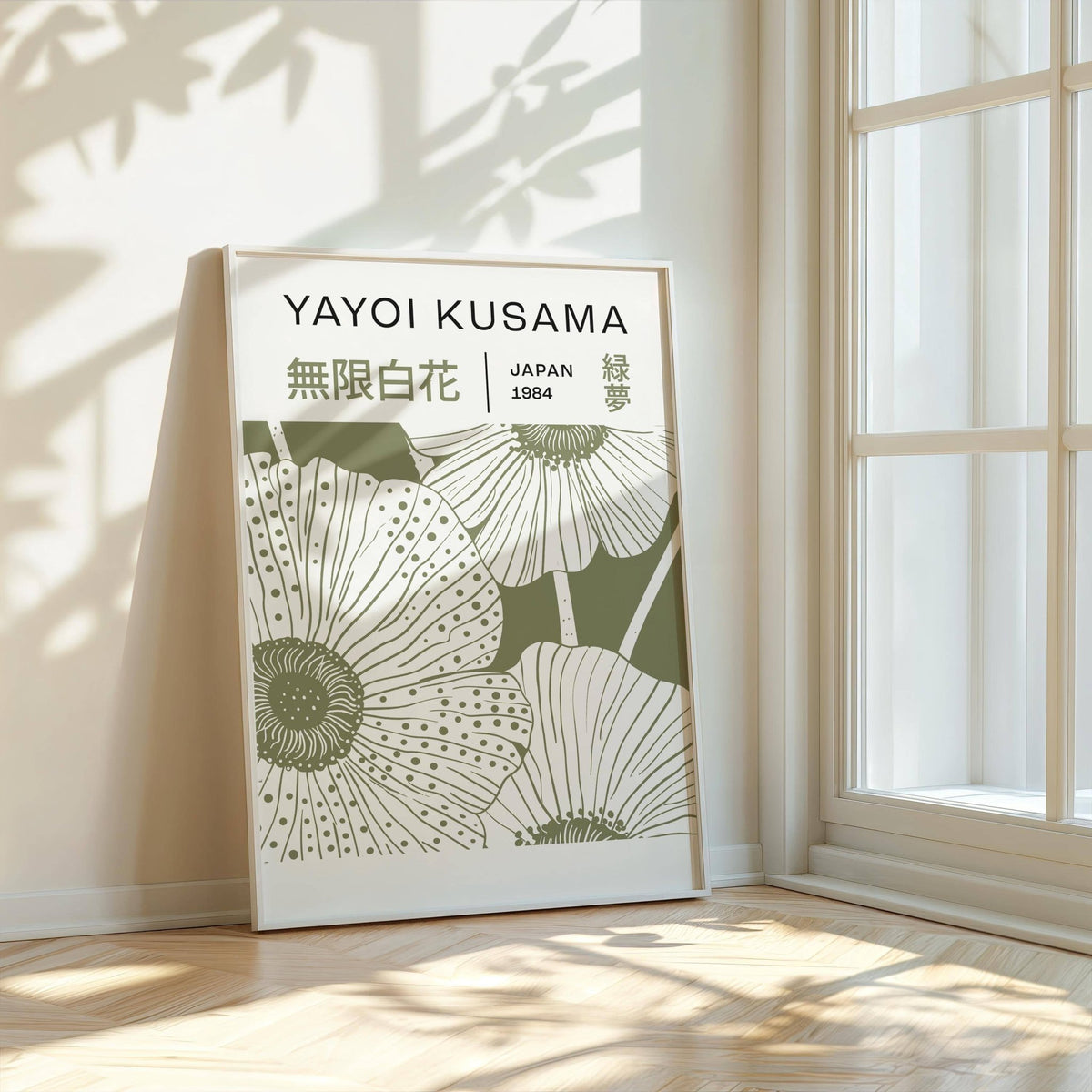 Print leaning on floor showing sage green poppies with typographic details near a large window