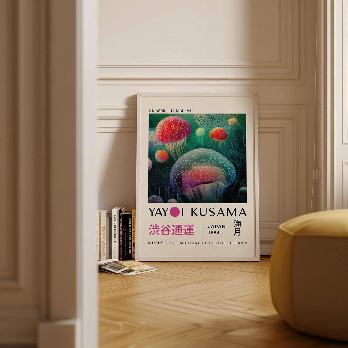 Print leaning on a wooden floor of glowing jellyfish with red and turquoise hues and text details beside stacked books