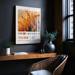 Autumnal wall art featuring orange wheat plants in a minimalist style on a dark wall above a wooden shelf with vases