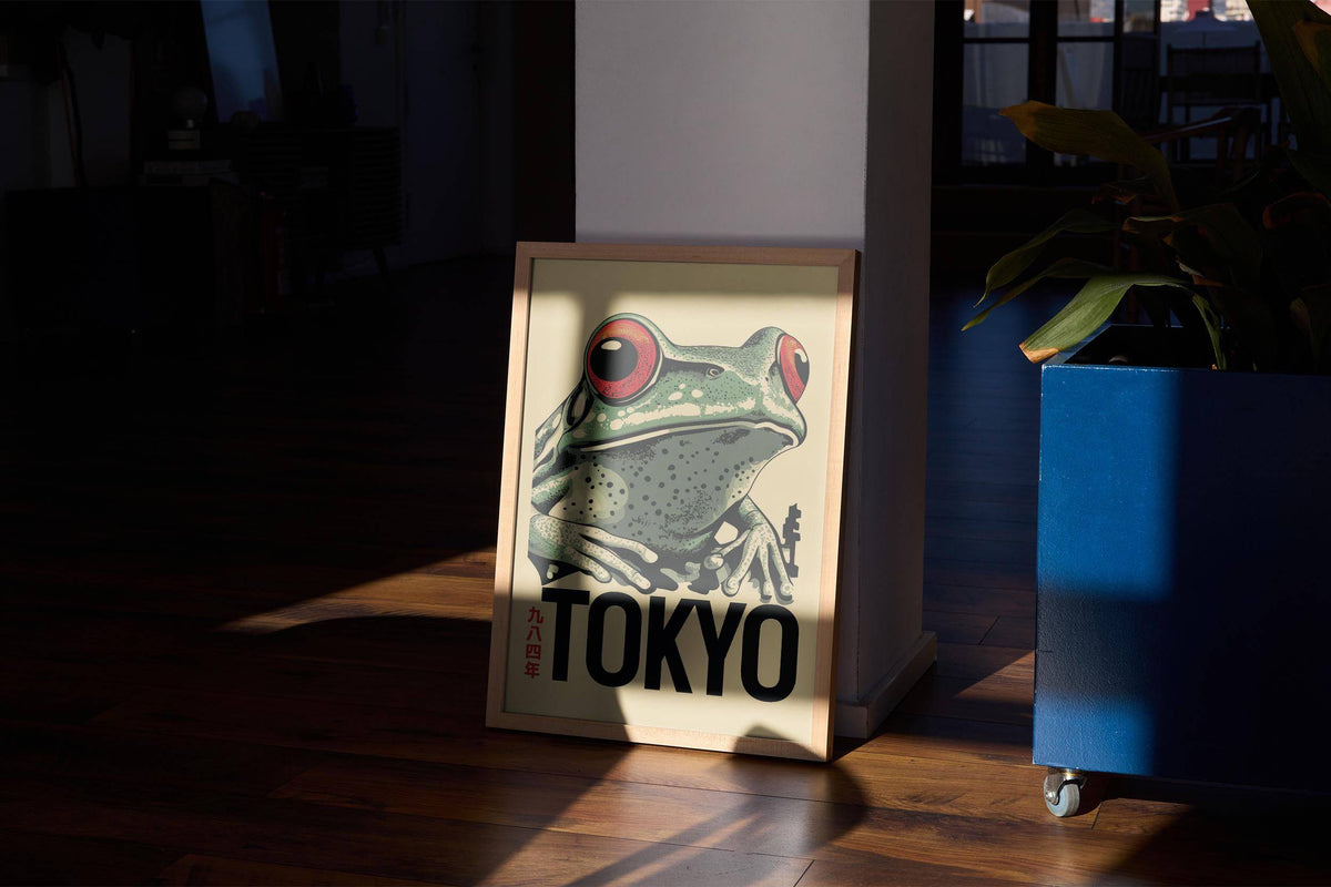 Frog poster leaning on the floor showing a red-eyed frog with a beige background and sunlight on wooden floor
