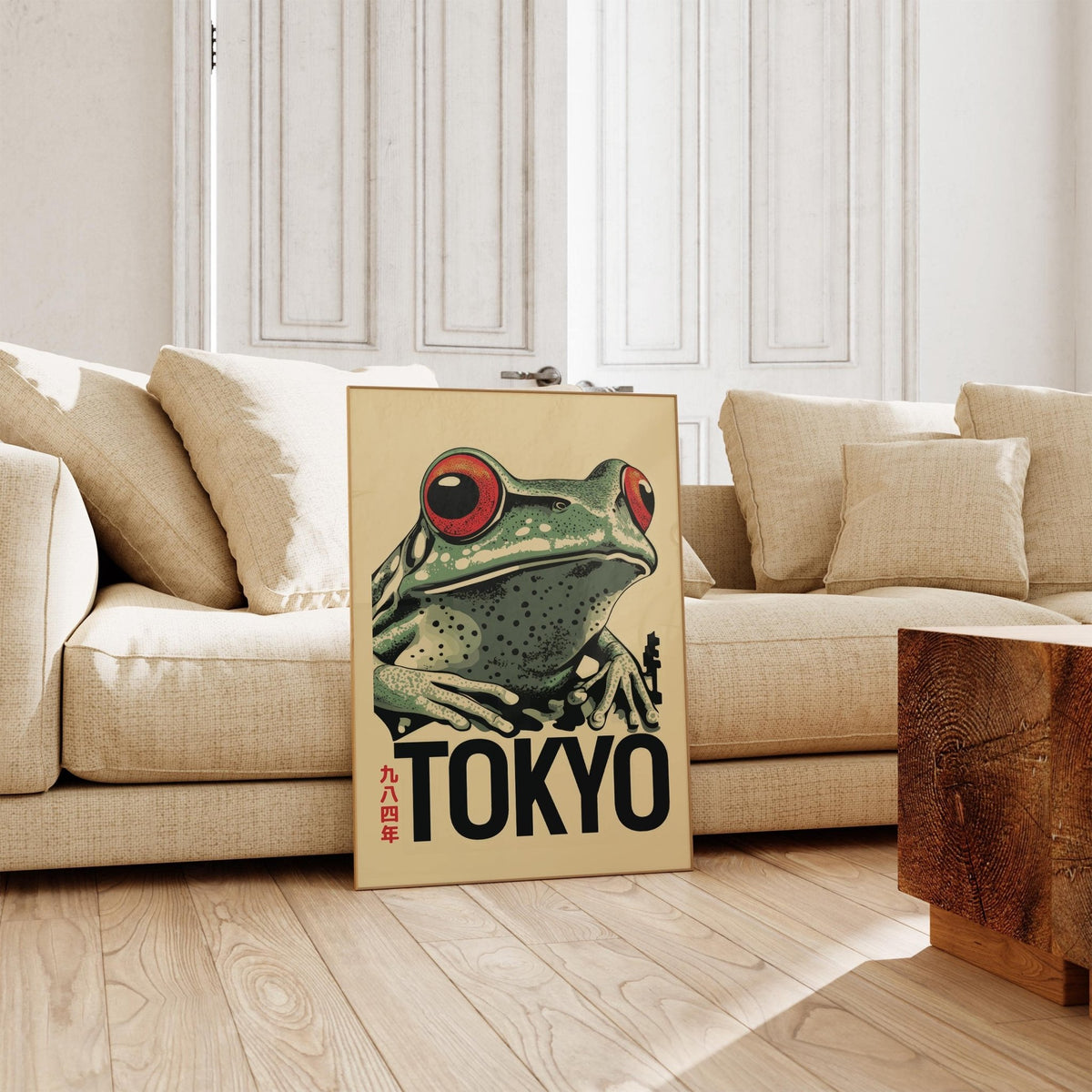 Frog Poster leaning with a red-eyed frog illustration and beige background by a cream sofa