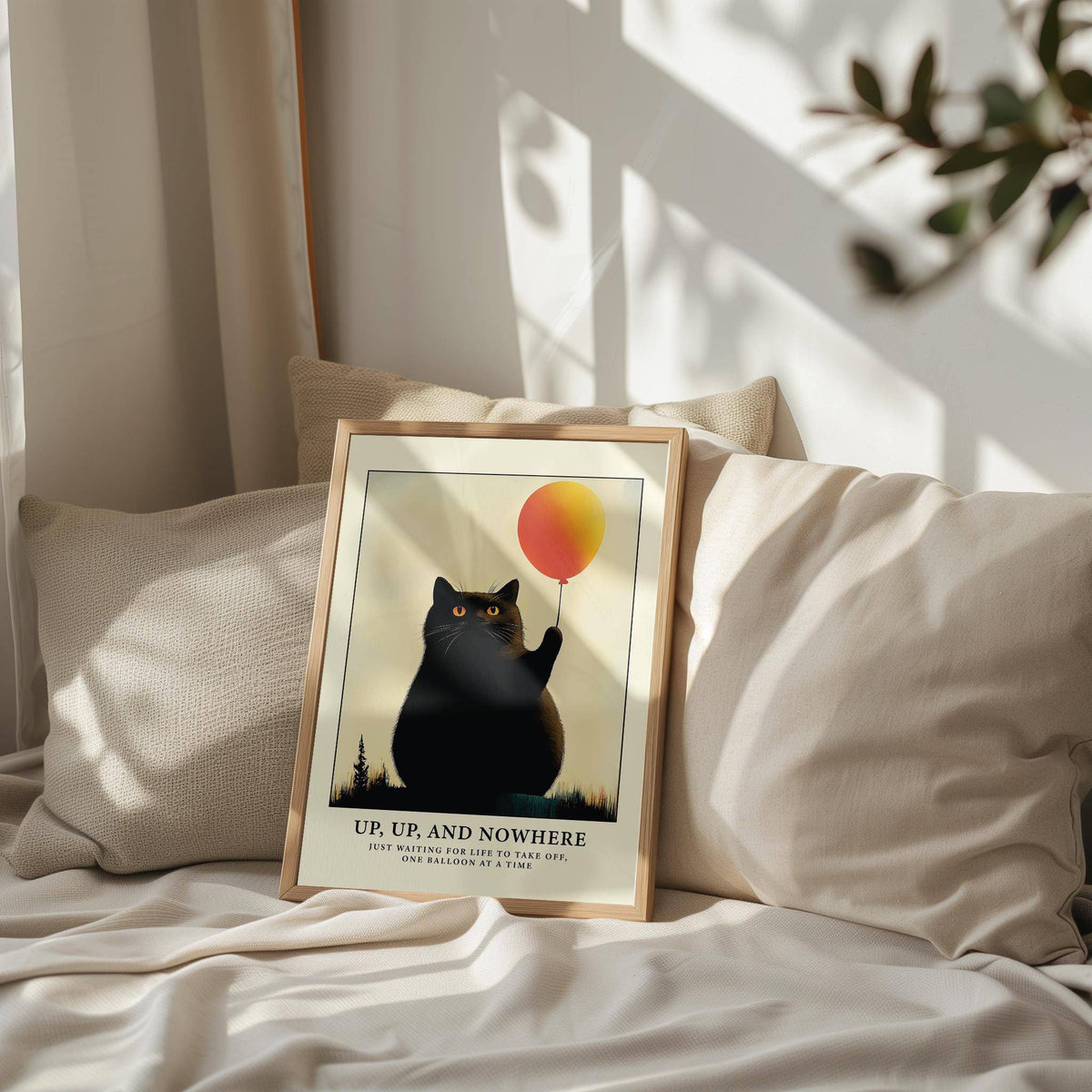 Framed Funny Cat Poster of a black cat holding a yellow and orange balloon leaning on a cushion