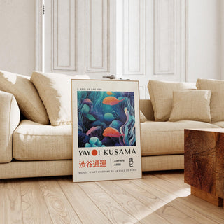 Colorful Fish Art print leaning on floor by beige sofa in bright room