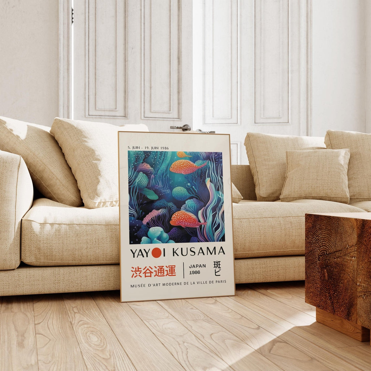 Colorful Fish Art print leaning on floor by beige sofa in bright room