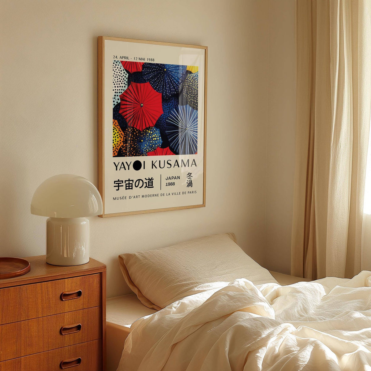 Japanese Home Decor print with colourful circular shapes hanging above a bed with white bedding and wooden bedside table