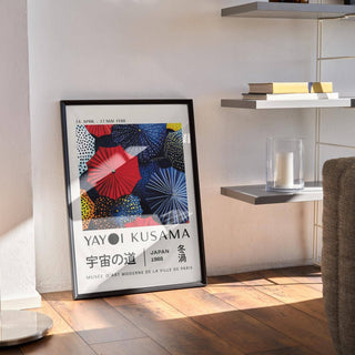 Japanese Home Decor print leaning against a wall near a floor lamp and shelf with books and candle