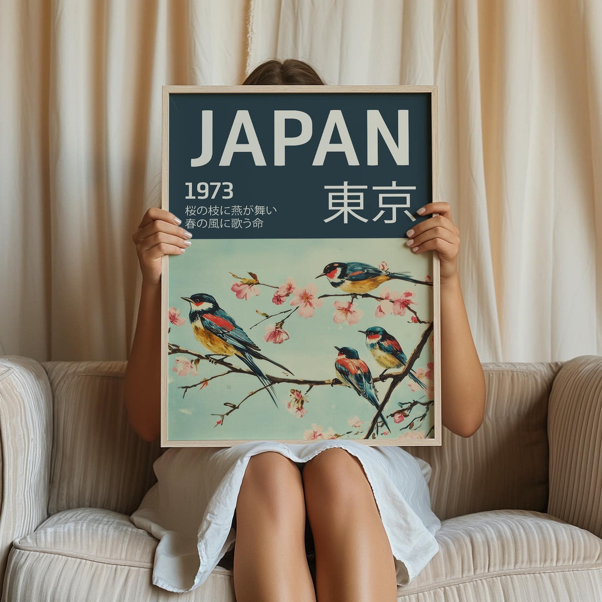 Framed Japanese Bird Wall Art held by person with swallows and cherry blossom branch in soft colours