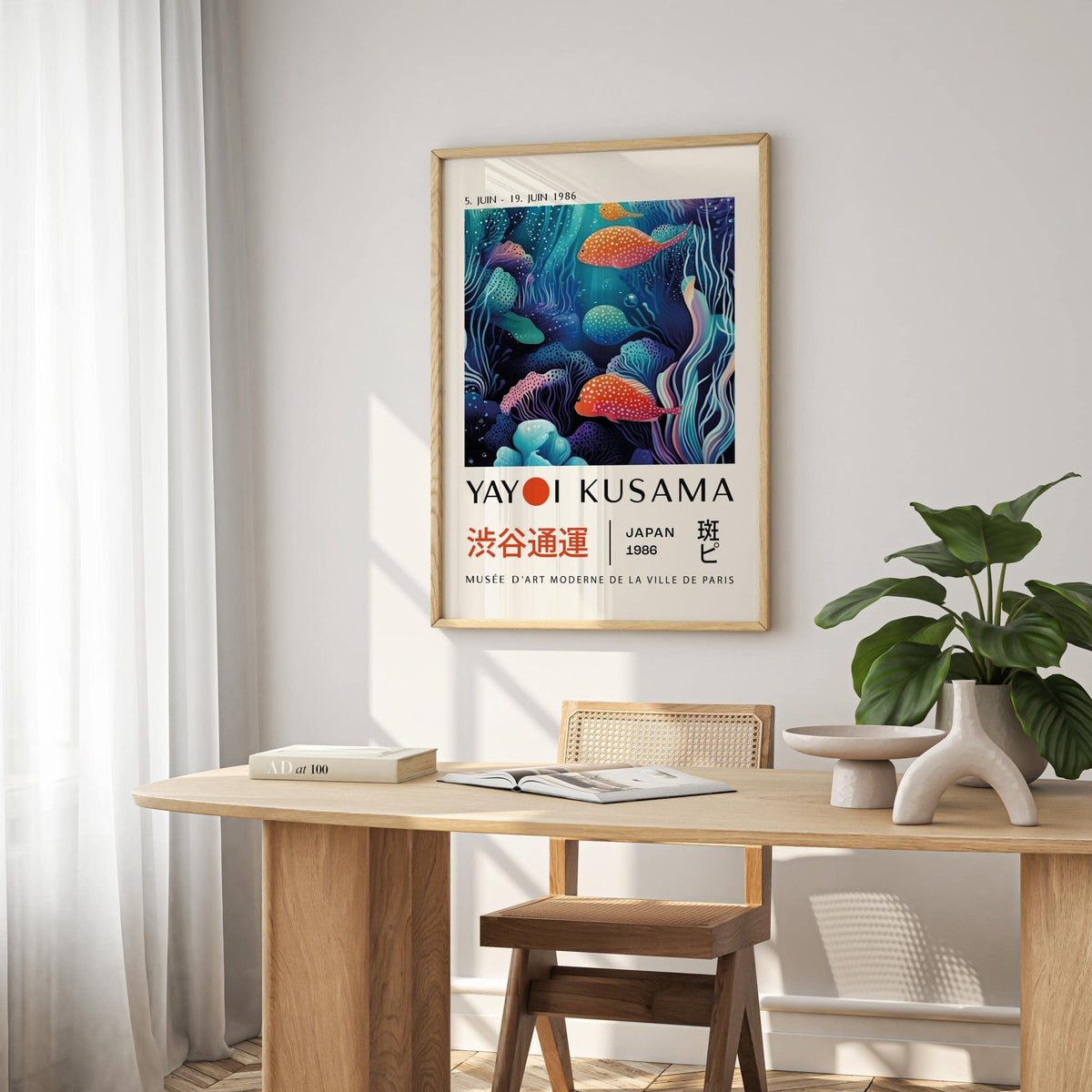 Colorful Fish Art print with spotted fish in blue and orange tones above a wooden table with books and a plant