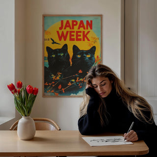 Retro wall prints of black cats with yellow eyes and autumn leaves above a wooden table with tulips