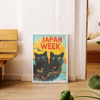 Retro wall prints featuring black cats with yellow eyes and bright yellow sun leaning on floor beside wooden bench