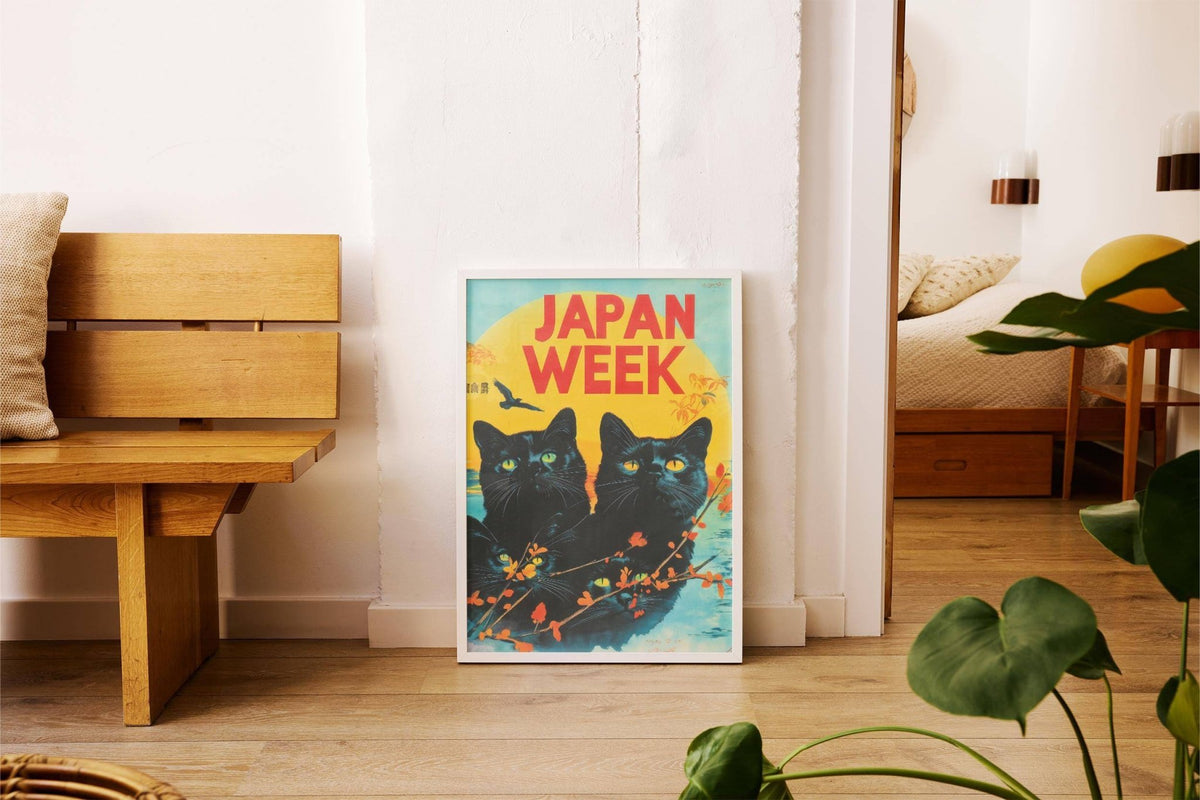 Retro wall prints featuring black cats with yellow eyes and bright yellow sun leaning on floor beside wooden bench