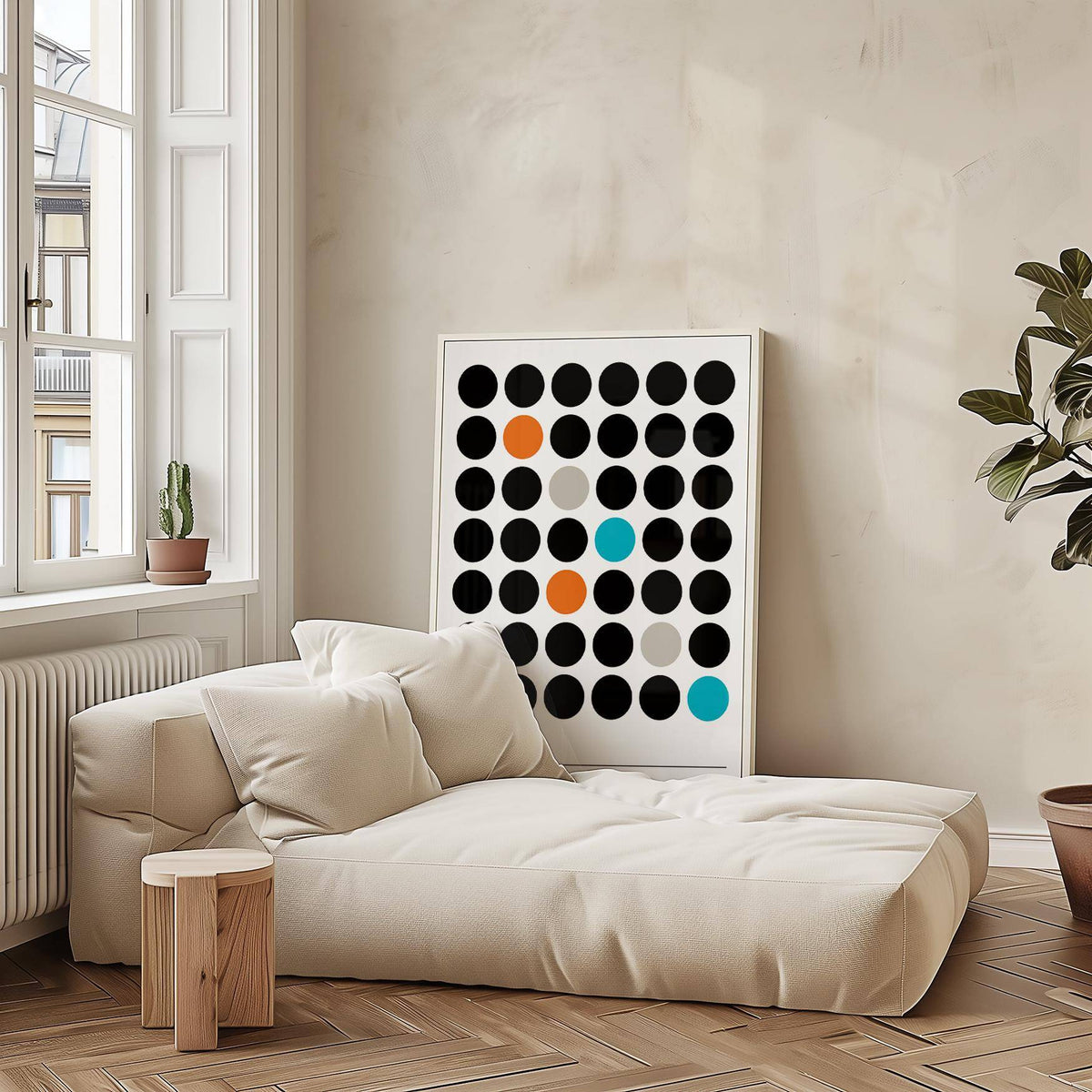 Graphic prints leaning on sofa with coloured dots grid in black orange blue and grey in beige room