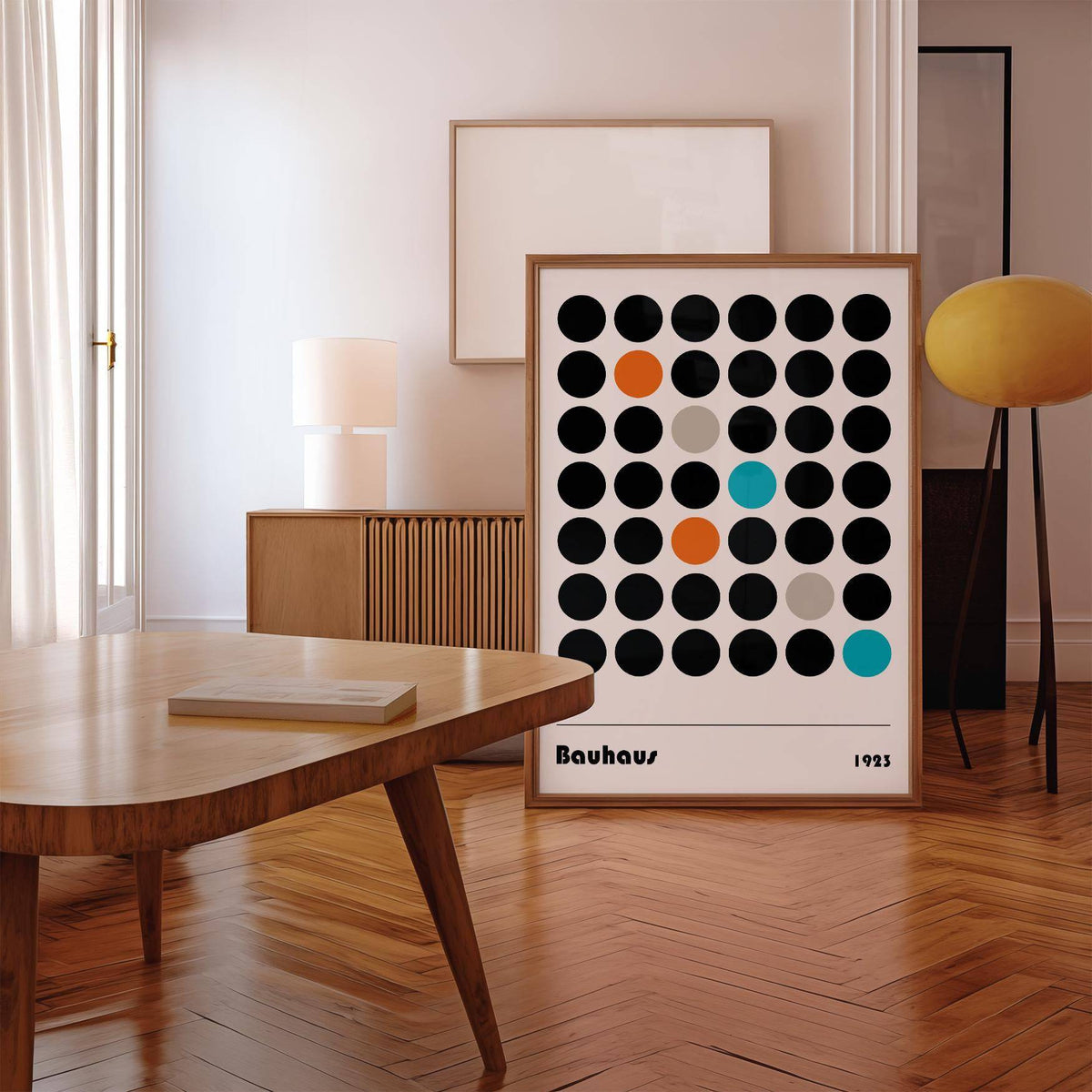 Graphic Prints leaning print with coloured dots in a minimalist room with wooden floor and yellow lamp