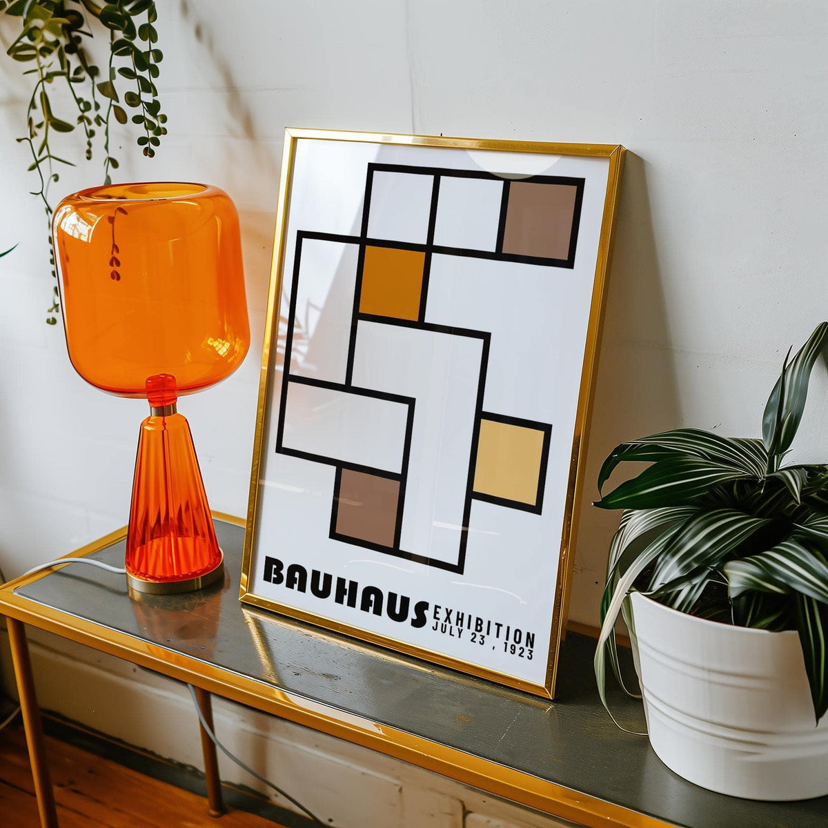 Framed close-up of geometric abstract art with colour blocks in orange and brown on a grey table
