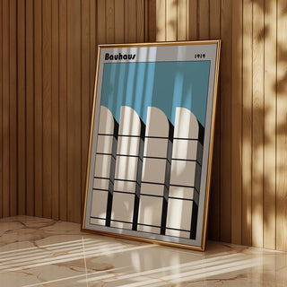 Framed Bauhaus Architecture Art Poster leaning on a marble floor with wooden wall background