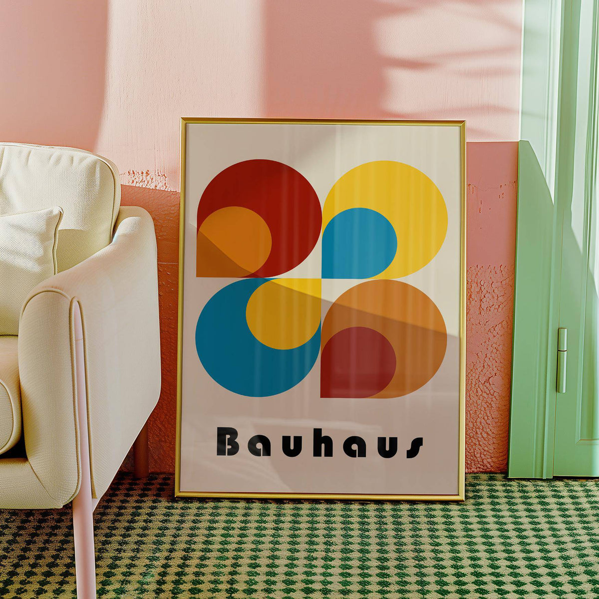 Framed geometric prints leaning on floor in gold frame featuring Bauhaus style shapes in red yellow blue and orange