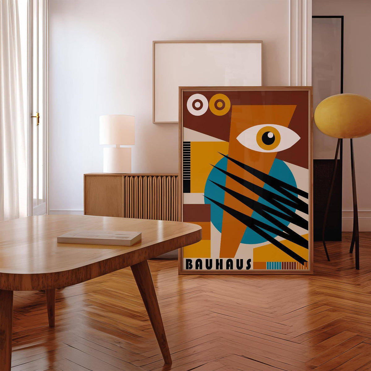 Geometric Poster leaning on floor showing abstract eye in brown, blue and yellow next to a lamp in a living room
