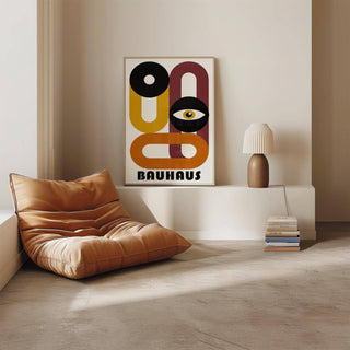 Retro Home Decor print leaning on a ledge with a brown chair and lamp nearby in a neutral room