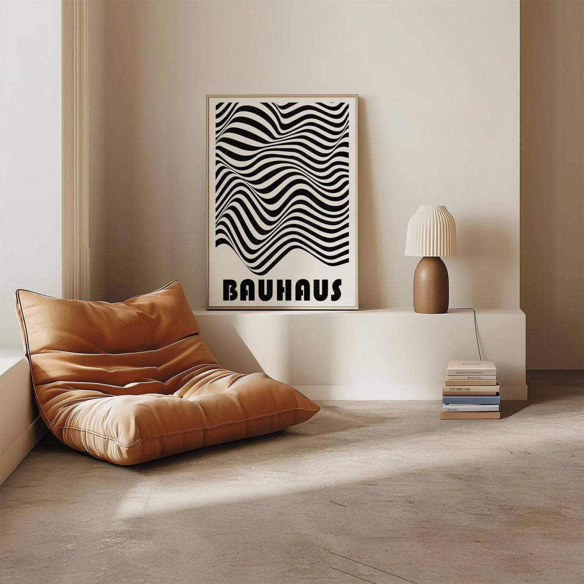 Graphic Art Print leaning on a low white shelf with a lamp and a stack of books near a brown cushioned chair