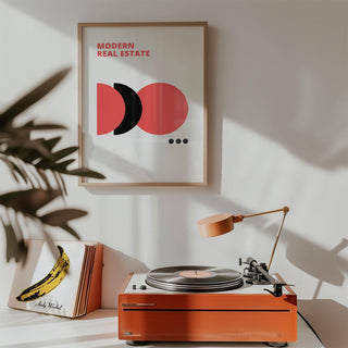 Red Black and White Wall Art with modern real estate text and abstract shapes above a red record player