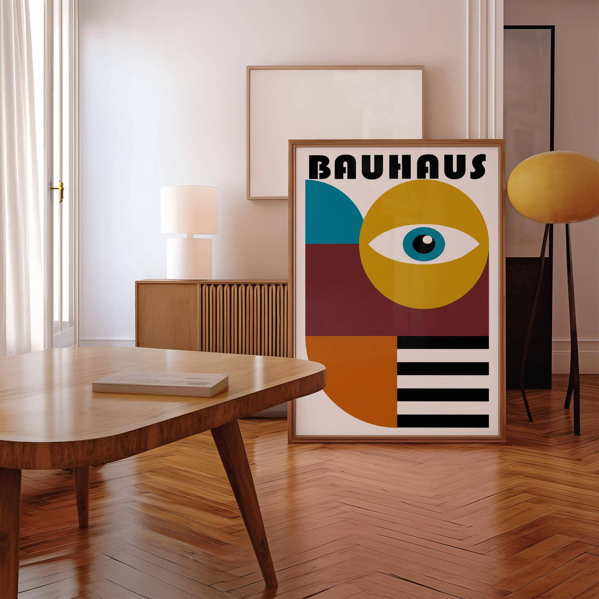 Retro wall art with a stylized eye and abstract shapes leaning on the floor by a yellow lamp