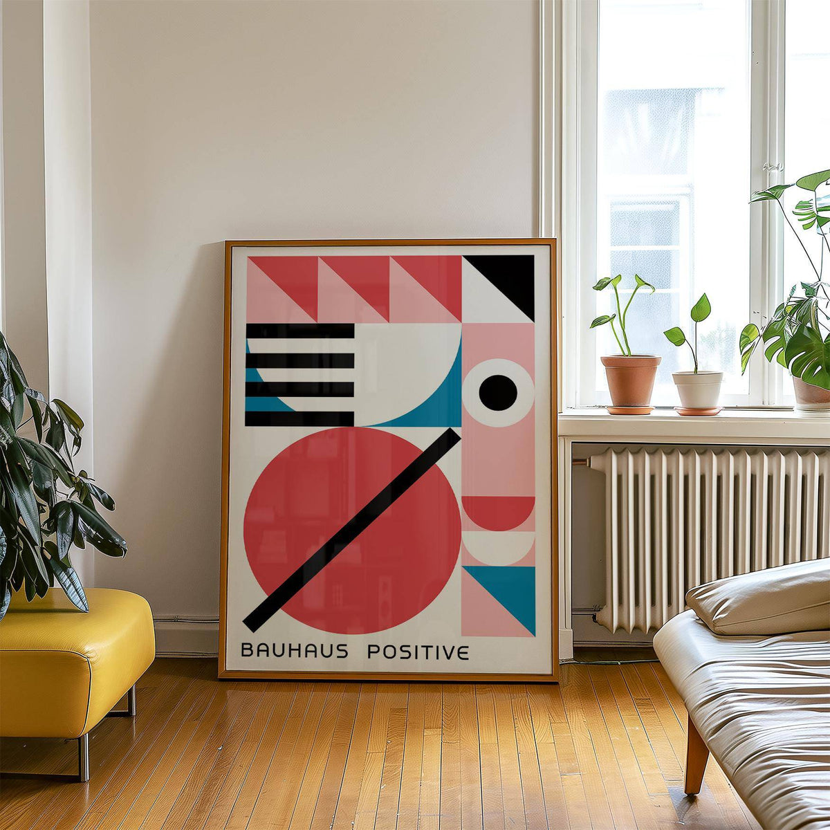 Print leaning on the floor with colourful geometric shapes in red, blue and black near plants and a radiator