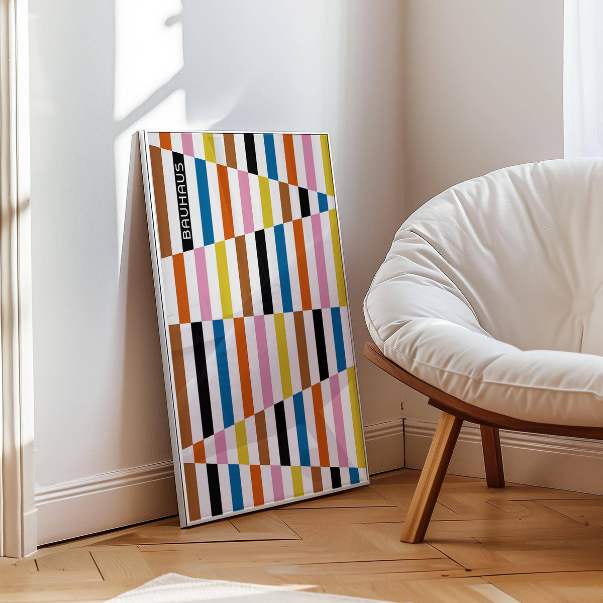 Print leaning on floor of Colourful Block Print with geometric blocks in bauhaus style and soft chair nearby