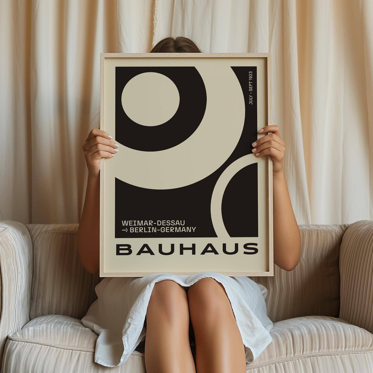 Minimalist Abstract Art Prints framed geometric Bauhaus design held by person on sofa with cream curtain