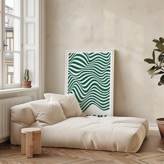 Green and white wall art with wavy stripes leaning on a wall above a low beige sofa with cushions in a bright room