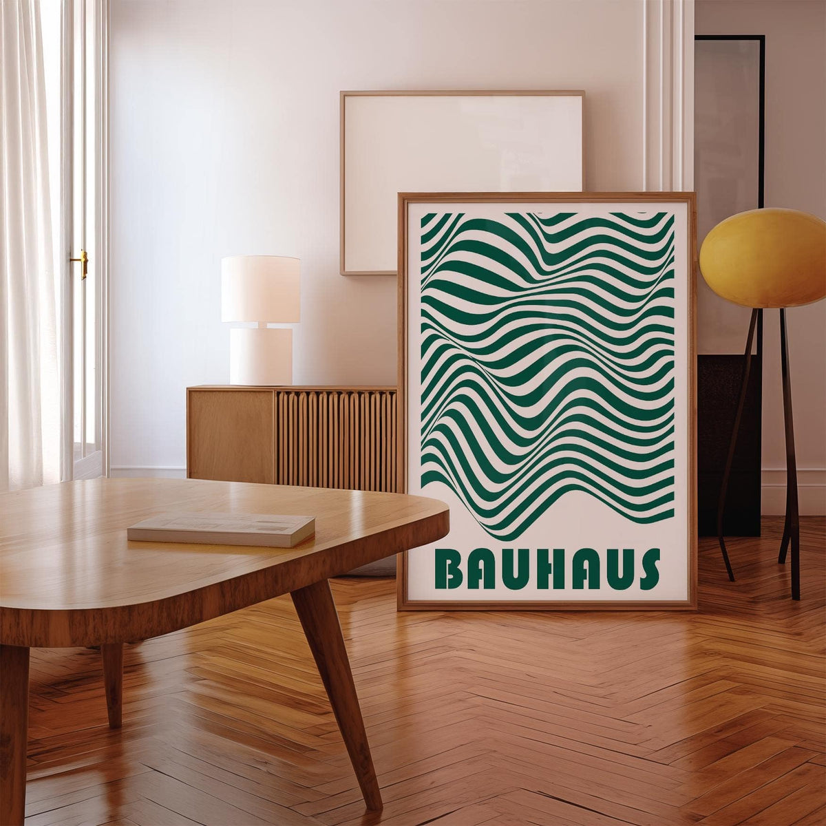 Green and White Wall Art with wavy stripes and text leaning on wooden floor next to a yellow lamp
