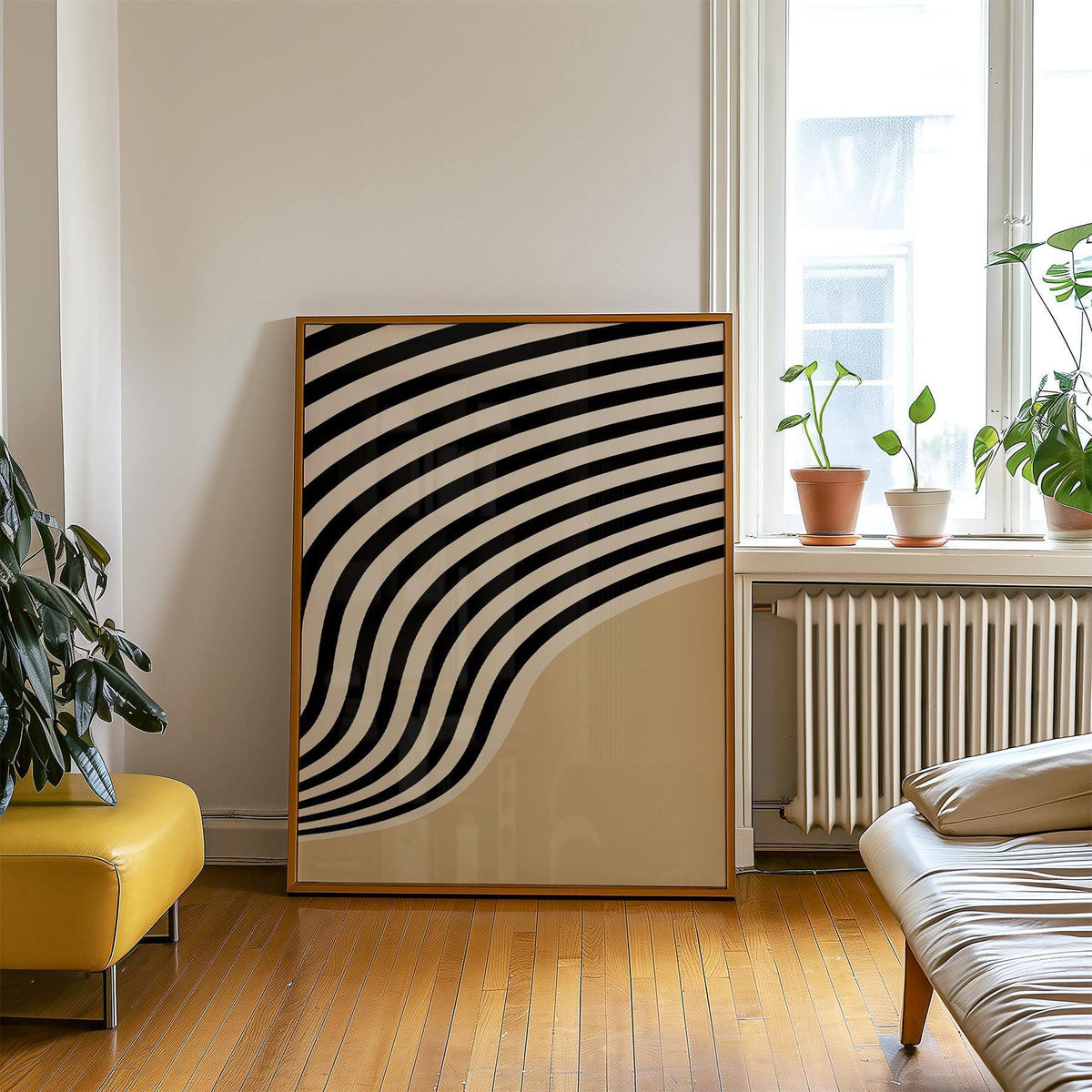 Print leaning on floor with beige abstract art of curved black and cream stripes near plants