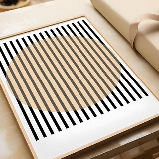 Framed Office Posters print with beige circle and black stripes on a wooden desk
